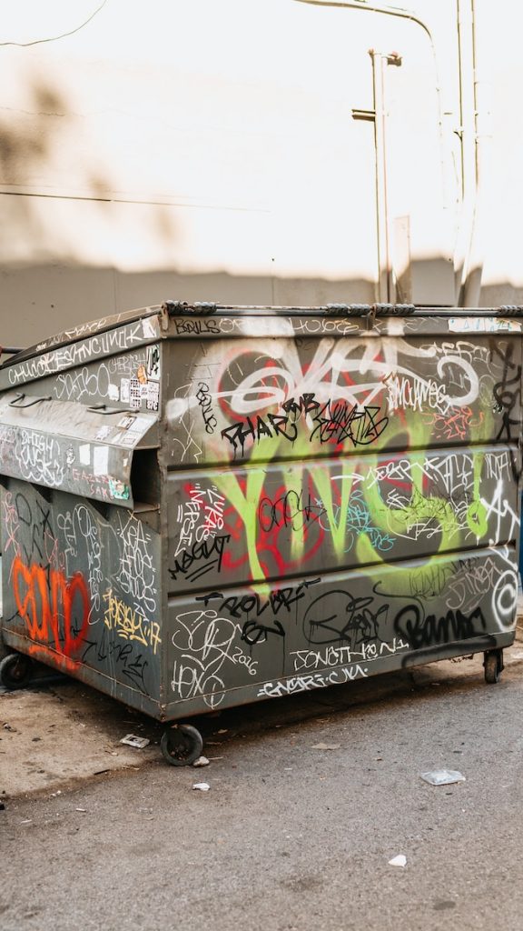 gray and white trash bin with paintings