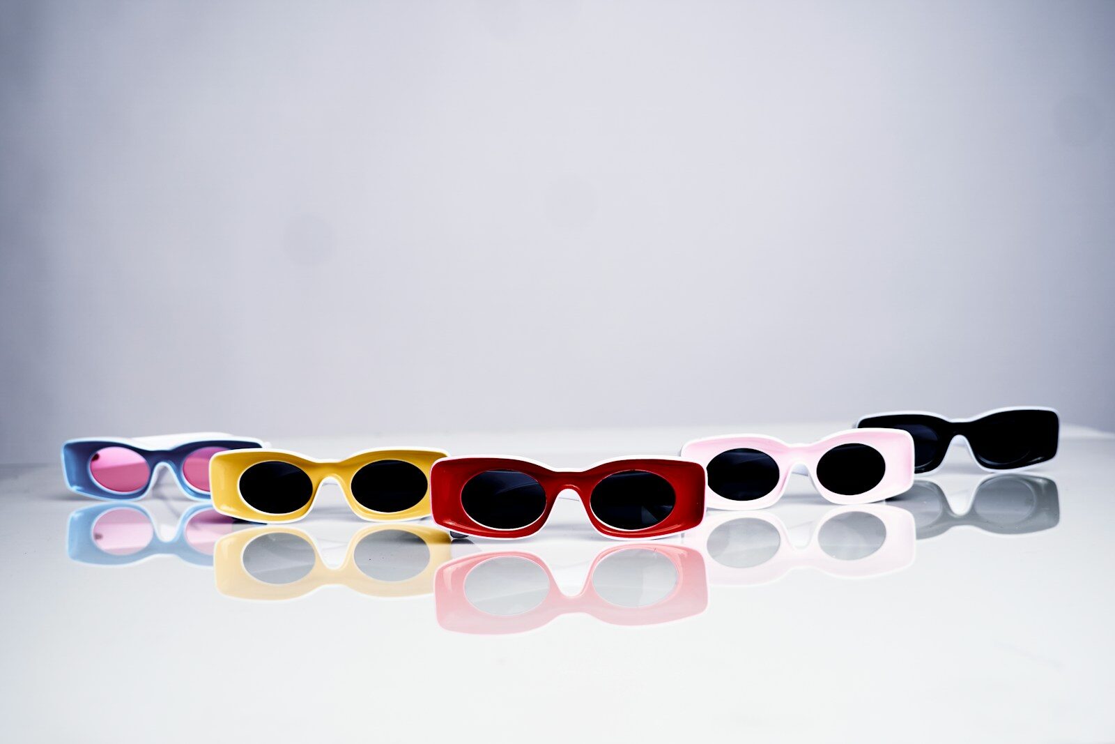 a row of sunglasses sitting on top of a table